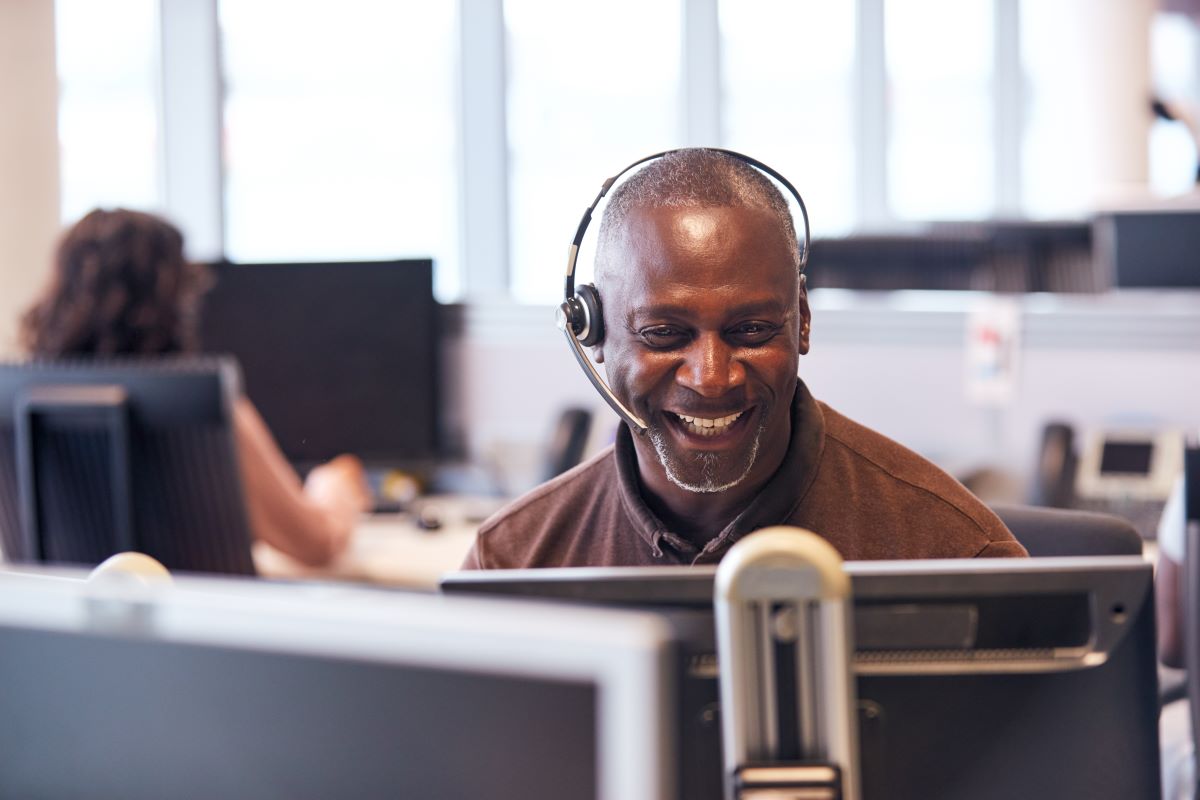 smiling man in office with phone headset