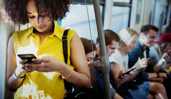 millennial woman texting on bus