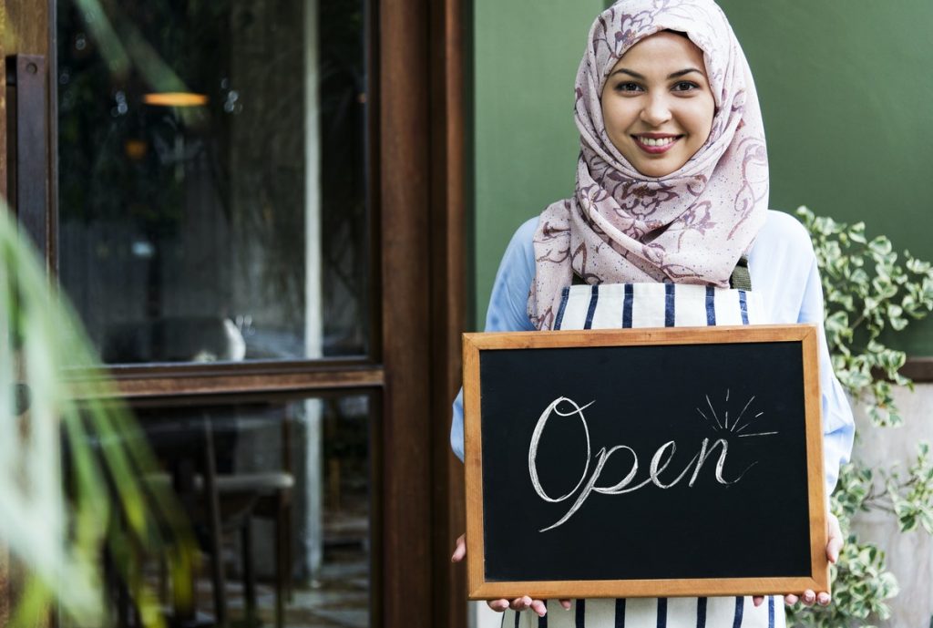 woman holding open sign small business concept
